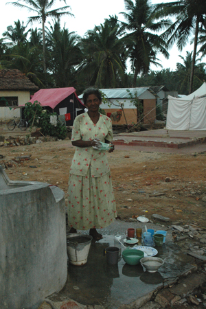 Washing dishes at one of the few sources of running water at the camp.