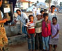 Some camp children in front of the water donated from Pakistan